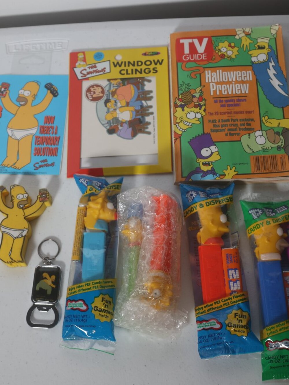 Lot of Simpsons: Pen, Bottle Opener, PEZ Candy Dispenser, TV Guide, Window Clamp